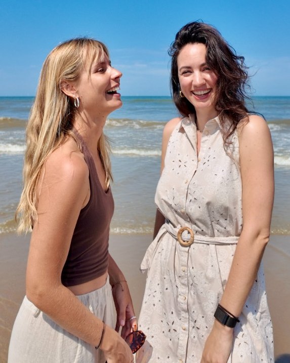 Ianna and Sofie laughing together on the beach