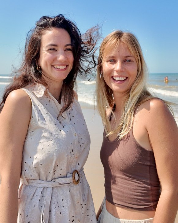 Ianna and Sofie smiling on the beach
